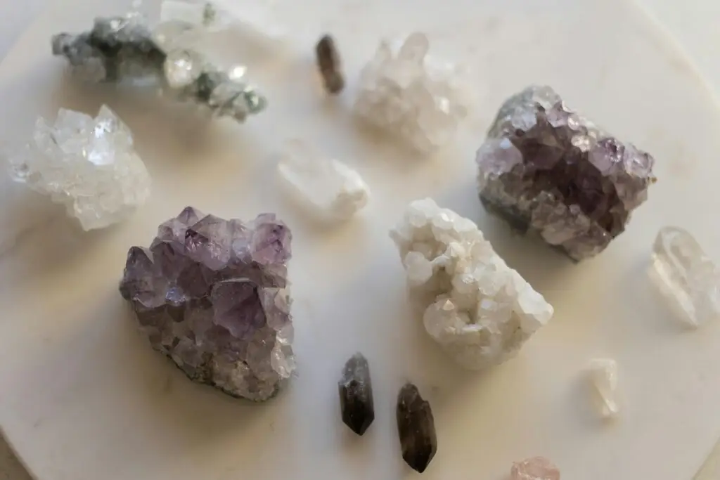 A stunning variety of natural crystals displayed on a marble surface. Perfect for decor or geology enthusiasts.
